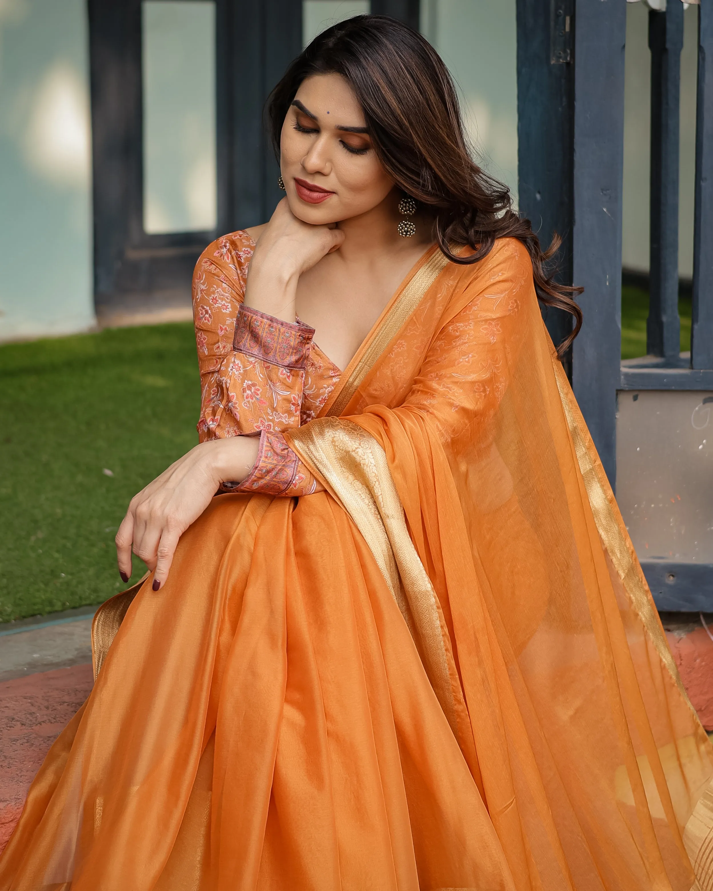 Sunset Orange Plain Chiffon Saree with Gold Zari Border, Floral Embroidered Blouse & Tassel Detailing